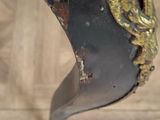 a close up of a metal object on a wooden floor