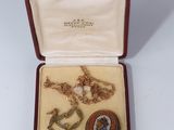 an image of a box with a necklace and two other items in it