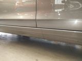 a close up of a car ' s side door with a cat sitting on it