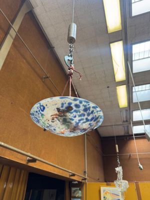 a blue and white bowl hanging from the ceiling