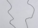 a silver necklace with a heart shaped pendant on a chain