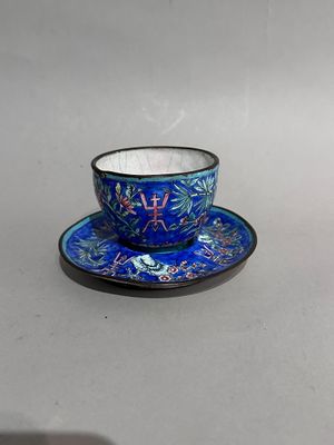 a blue cup and saucer on a white table