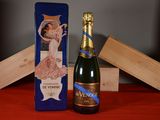 a bottle of champagne sitting next to a wooden box