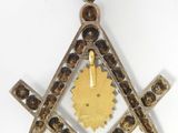 a close up of a masonic square and compass symbol on a white background
