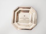 an image of a silver plate on a white surface