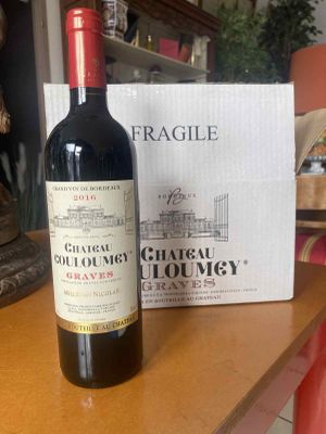 a bottle of wine sitting on a table next to a box of wine