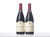 two bottles of wine sitting on top of a white table