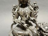 a statue of a woman sitting on top of a lion