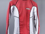 red and white long sleeved shirt hanging on a hanger