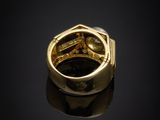 an image of a gold ring on a black surface