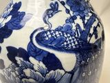 a blue and white vase with a bird on it