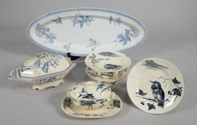 several pieces of blue and white china on a table