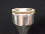 a silver cup that is sitting on a black table