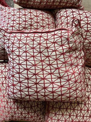 a pile of pillows sitting on top of each other on the floor