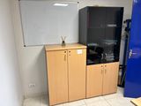 a refrigerator and cabinets in a room with a blue door