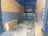 a blue van with wood in the back of it