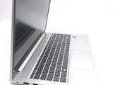 a silver laptop computer sitting on a white surface