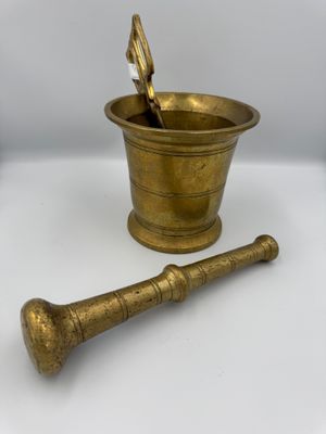 antique brass mortar and pestula with a wooden handle