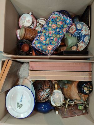 a cardboard box filled with a variety of decorative items