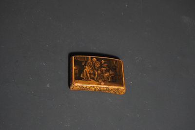 a picture of a gold plate with a picture of a group of people on it