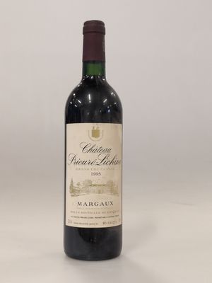 une bouteille de vin rouge posée sur une table blanche