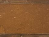 an old wooden frame with a piece of fabric on top of it