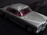 a toy car that is sitting on a black surface