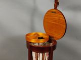 a small wooden table with a lamp on top of it