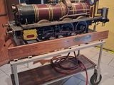 a model train sitting on a cart in a room