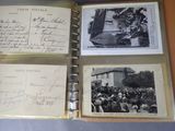 an old photo of a group of people gathered around a book