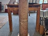 a marble column on the floor in a room