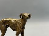 a statue of a dog that is standing on a table