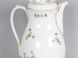 a white coffee pot with blue flowers on it