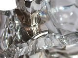 a glass candle holder with a crystal candle on top of it