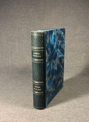 an old book sitting on top of a table with a blue cover
