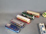 a lot of toy cars and buses on the floor