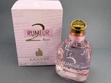 a bottle of perfume sitting next to a box on a table