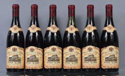 six bottles of wine are lined up in a row on a table