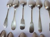 six spoons and a pair of shoes on the table