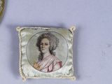 a small picture of a woman on a pillow