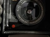 a black camera sitting in a box on a table