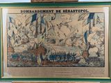 framed picture of a painting of a battle with a ship in the background
