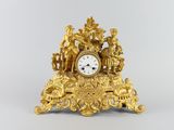 a gold clock that is sitting on top of a table