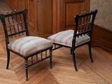 two chairs sitting next to each other on a wooden floor