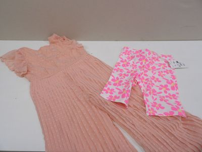 two pieces of clothing are laying on a white surface