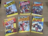 several comics are lined up on a table in front of each other