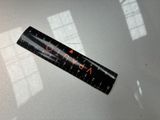a close up of a ruler sitting on top of a table next to a window
