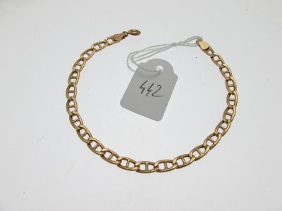 a close up of a gold chain bracelet with a price tag