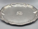 a silver plate with a lion on it on a table
