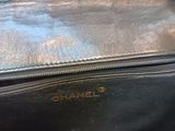 a close up of a black purse with a gold handle